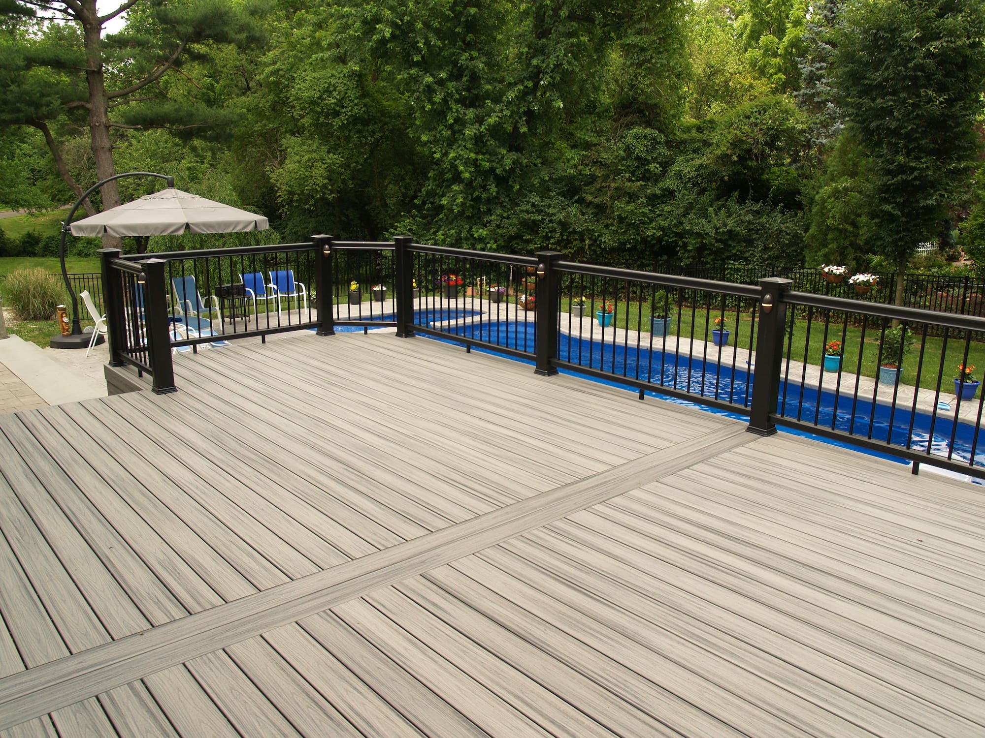 McHenry deck overlooking a pool in a backyard.