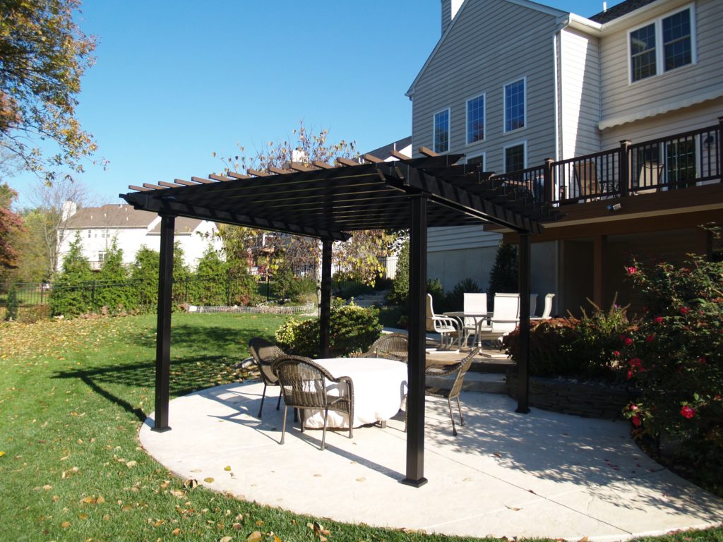 Patio with overhead black wood covering build by McHenry Decks