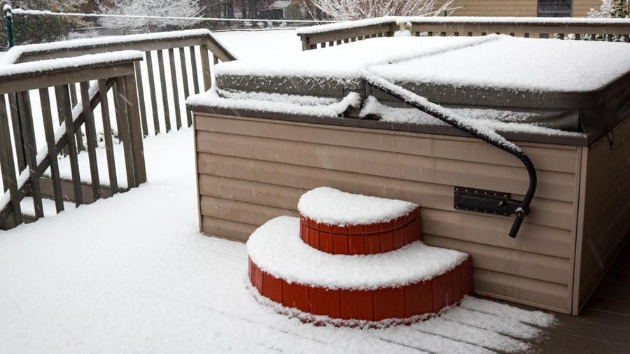 Hot Tub on A Deck Covered in Snow